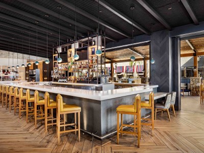 Open, airy seating inside Wolfgang Puck Kitchen + Bar